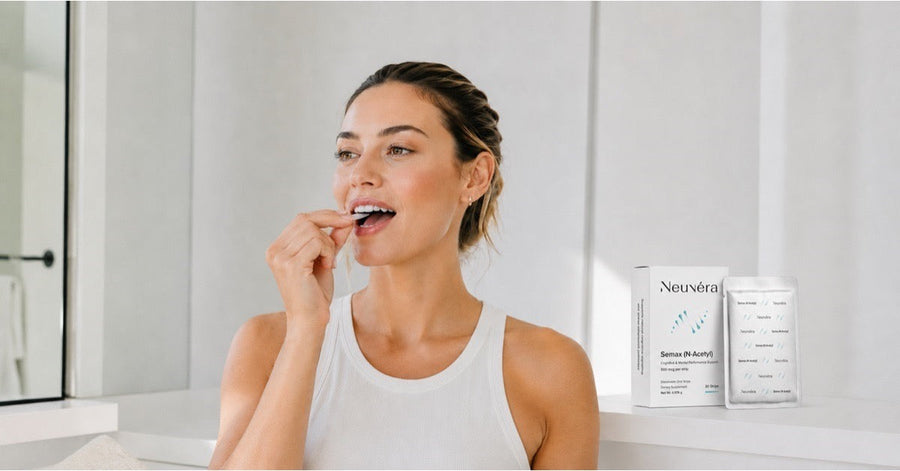 Woman placing a Neuvéra Semax N-Acetyl oral dissolving strip on her tongue